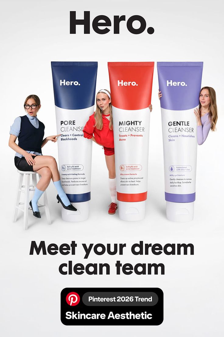 Three women posing with large skincare product tubes on a white background