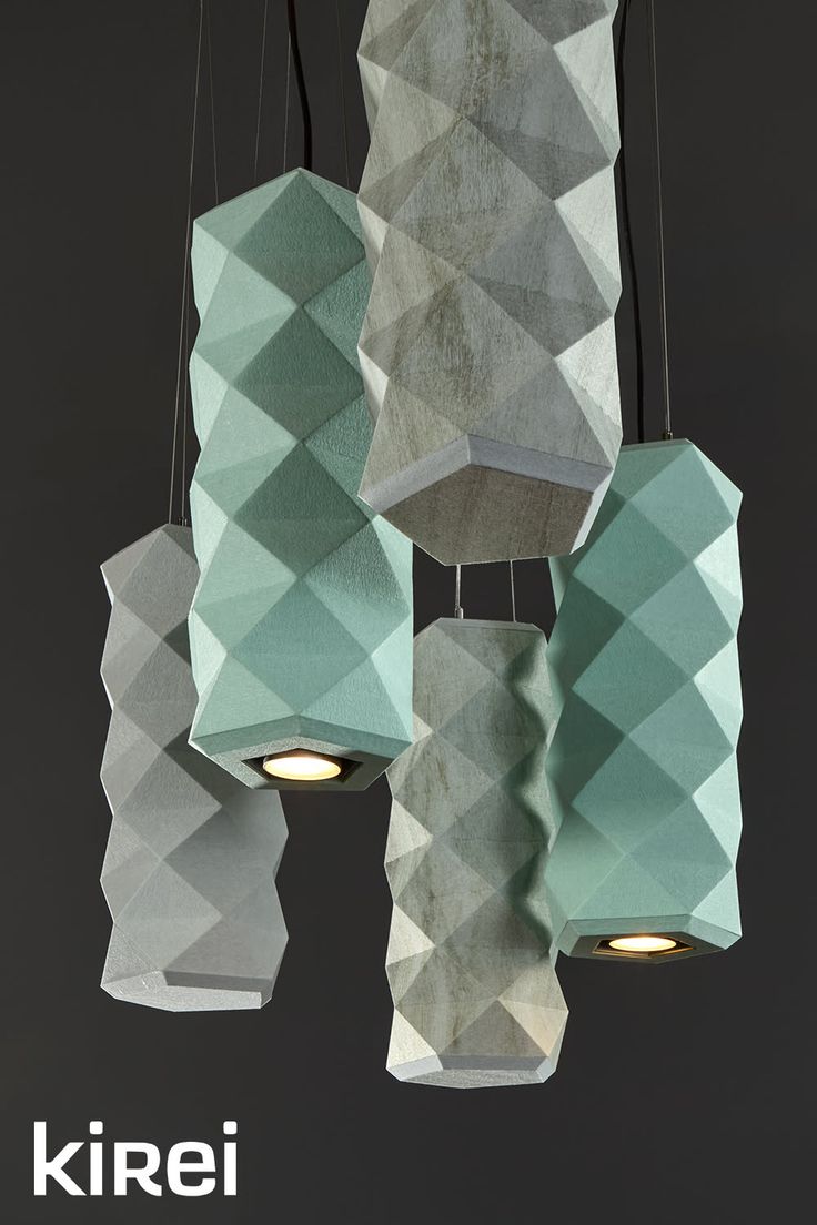 Group of geometric pendant lights with textured surfaces in mint green and gray