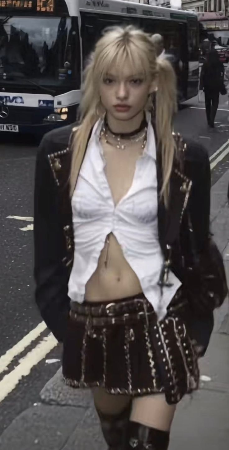 Blonde woman with pigtails in a mini skirt and open shirt on a street
