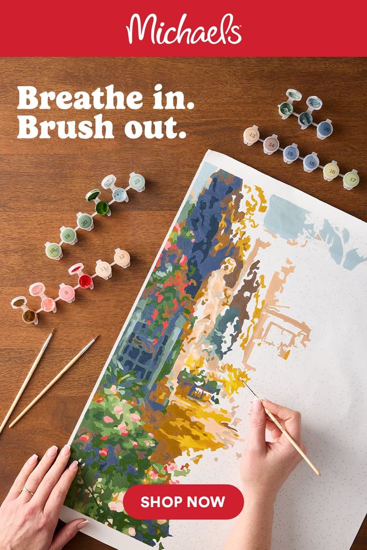 Overhead shot of a person painting a landscape with a paint by number kit