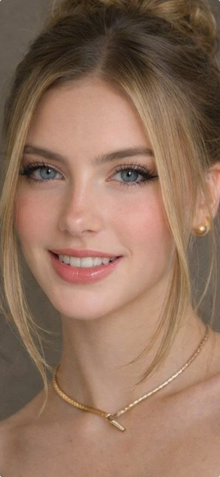 Woman with blonde hair and blue eyes wearing gold jewelry