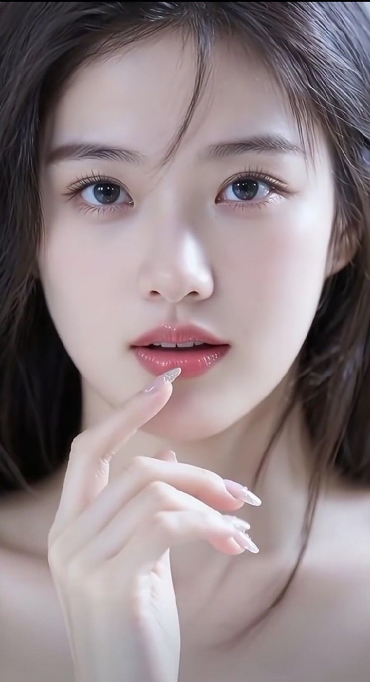 Close up portrait of a woman with long dark hair and blue eyes