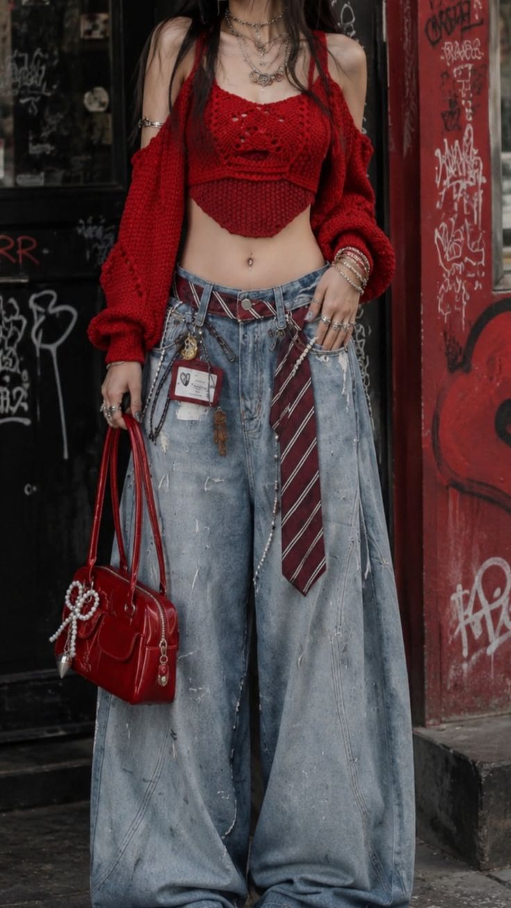 Person in a red crop top and baggy jeans with a red handbag