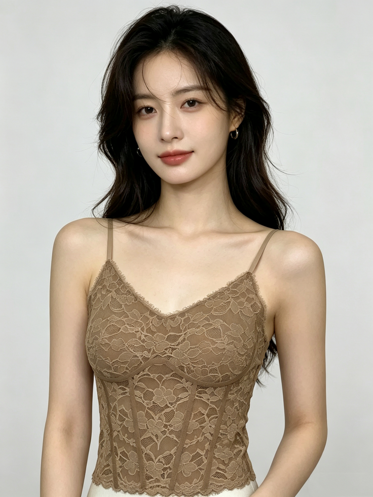 Woman with long dark hair wearing a brown lace top and small hoop earrings