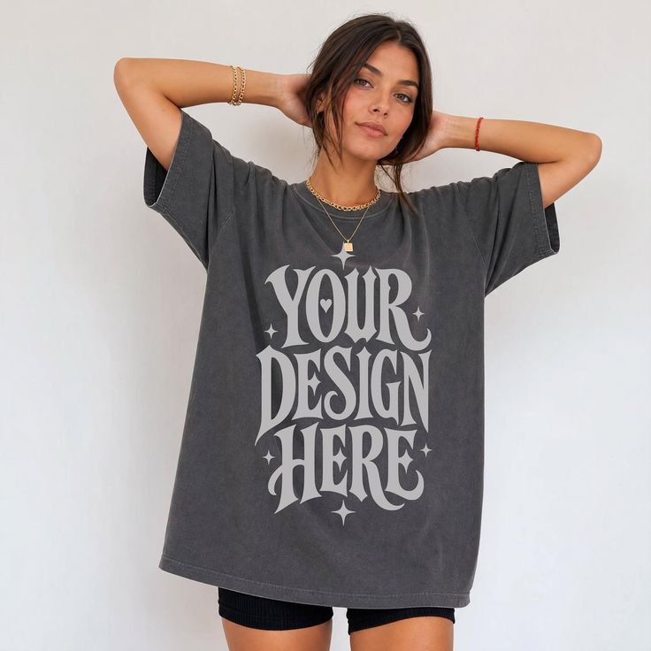 Woman in an oversized dark t-shirt and short shorts with hands behind her head