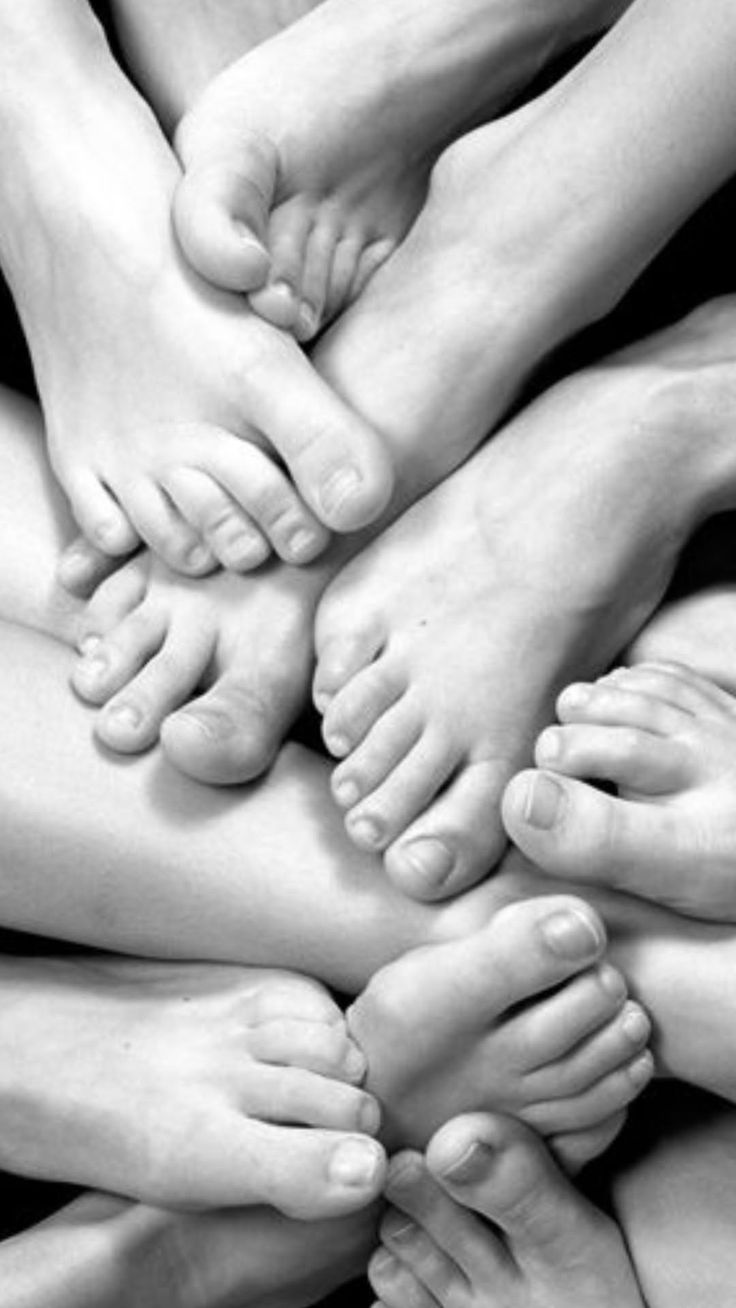Close up of multiple intertwined feet in black and white