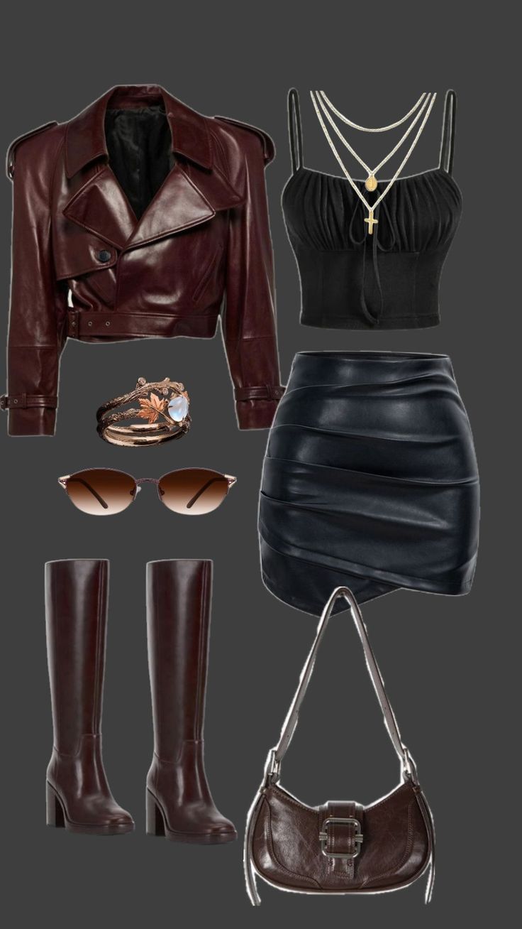 A flat lay of a dark brown leather jacket, black crop top, and black leather skirt