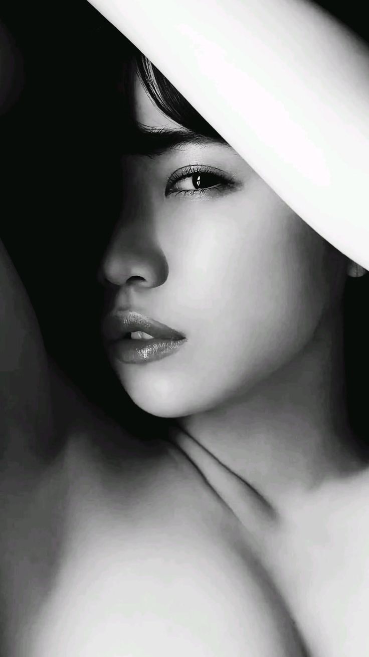 Close up black and white portrait with dramatic lighting and exposed skin