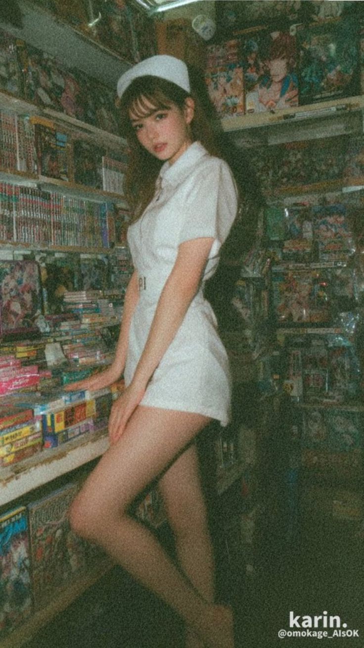 Woman in a nurse uniform posing in an indoor setting with film grain