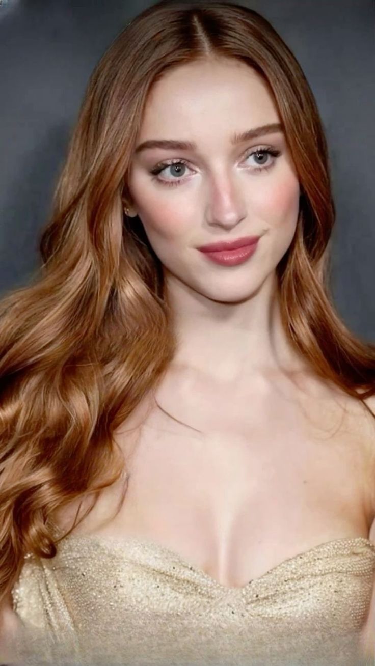 Woman with long red hair wearing a strapless dress, upper body portrait