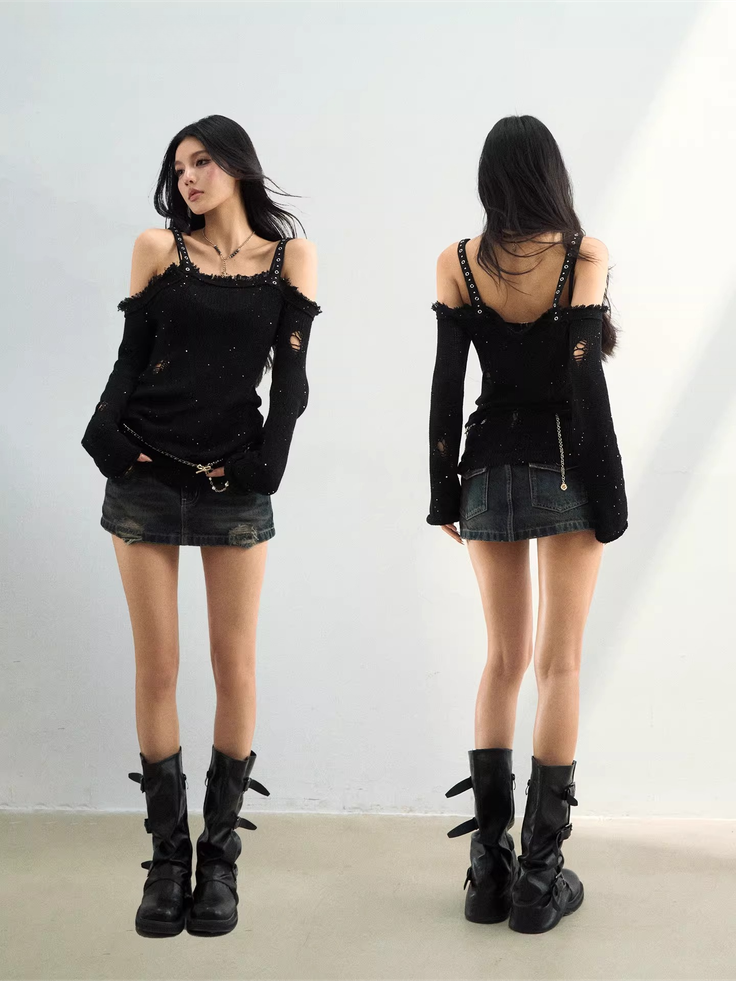 Woman in a black distressed top, denim skirt, and black boots