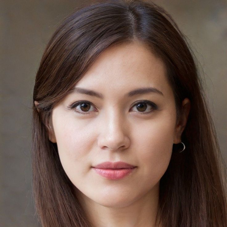 Woman with long brown hair and brown eyes wearing a small hoop earring