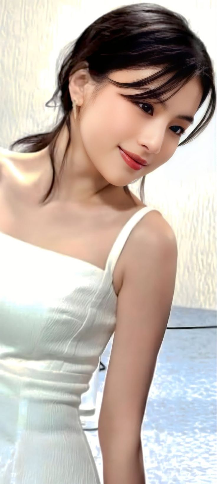 Woman in a white dress with dark hair and red lips, looking down