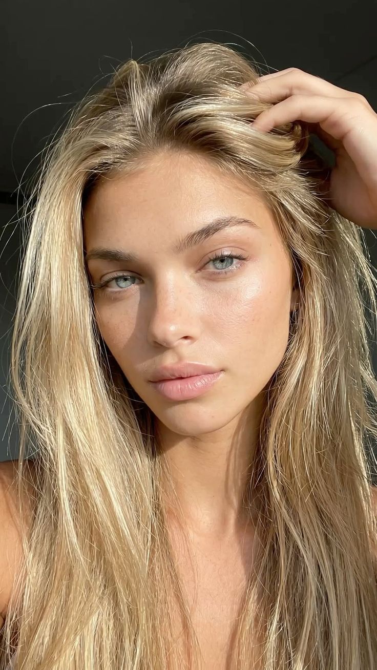 Woman with blonde hair and blue eyes in soft golden hour lighting