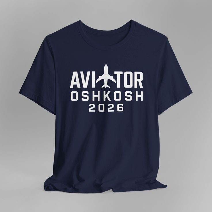 Navy blue t-shirt with 'AVIATOR OSHKOSH 2026' text and an airplane graphic