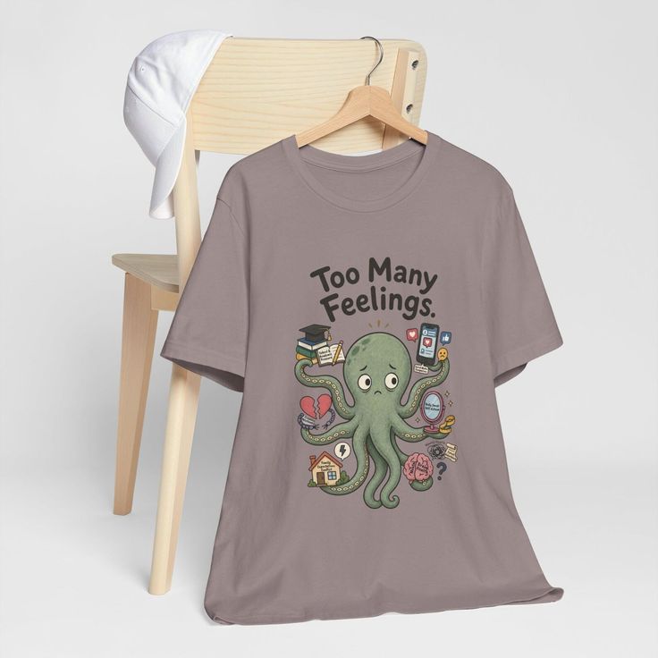 T-shirt with a cartoon octopus holding various items and text 'Too Many Feelings'
