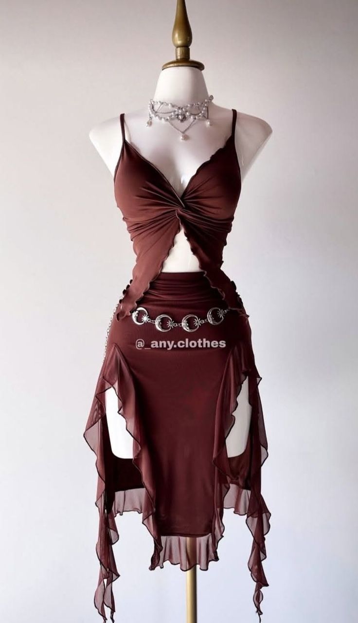 Brown two-piece outfit with a ruffled skirt and silver chain belt on a mannequin