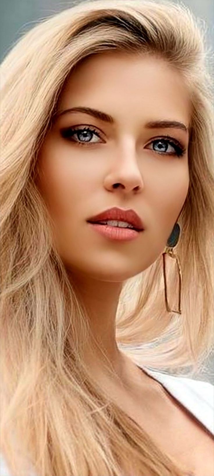 Close up portrait of a woman with blonde hair and blue eyes