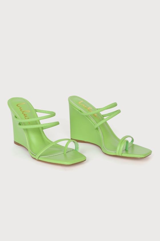 Pair of lime green wedge sandals with a square toe and strappy design