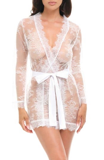 Woman in a white lace robe with a white ribbon tie