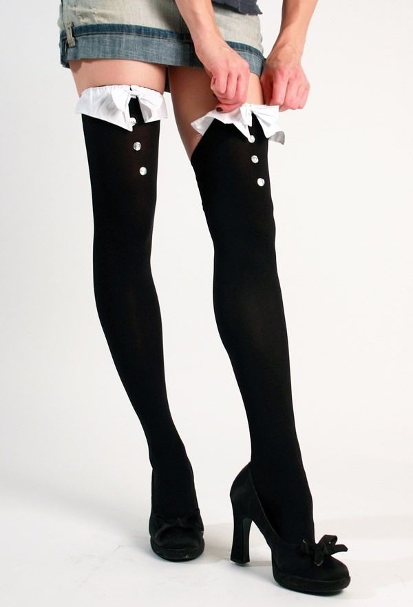 Person in thigh-high socks and a denim skirt adjusting their clothing