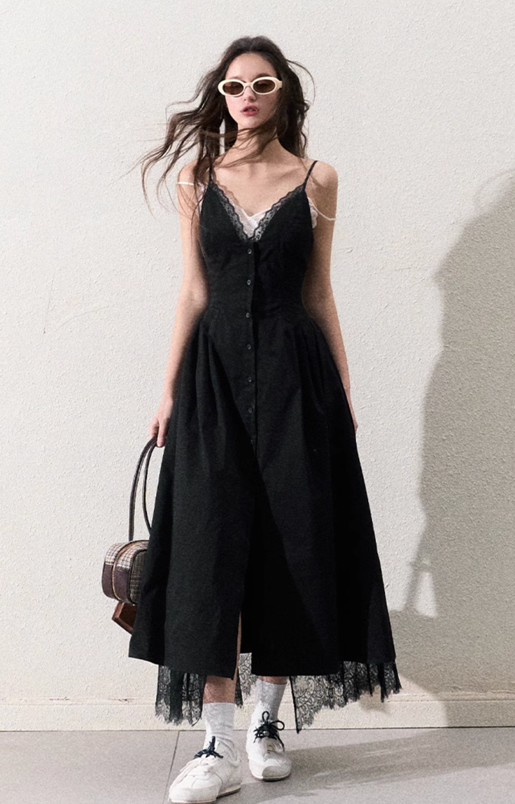 Woman in a black dress with lace trim, white socks, and sunglasses