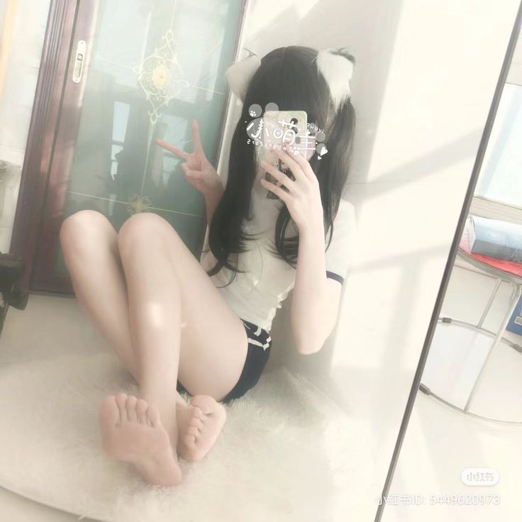 Person with cat ears and pigtails in a white t-shirt and athletic shorts