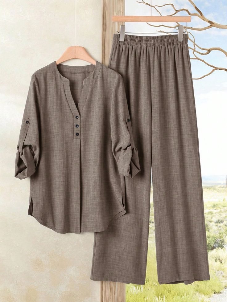 Brown long sleeve shirt and wide leg pants hanging against an outdoor background
