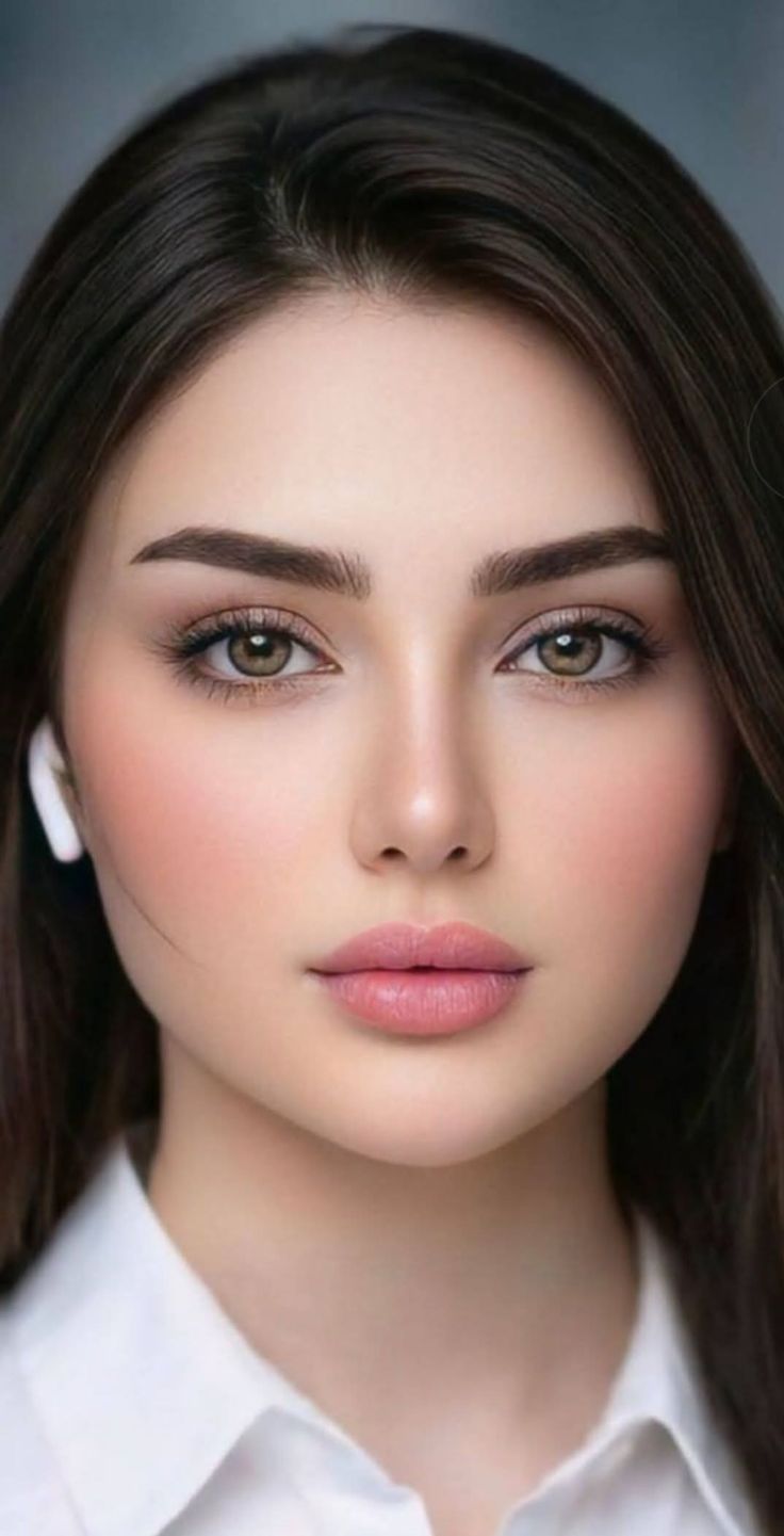 Close up portrait of a woman with dark hair and an earbud