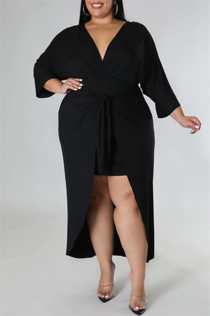 Woman in a black dress with a high slit and v-neck