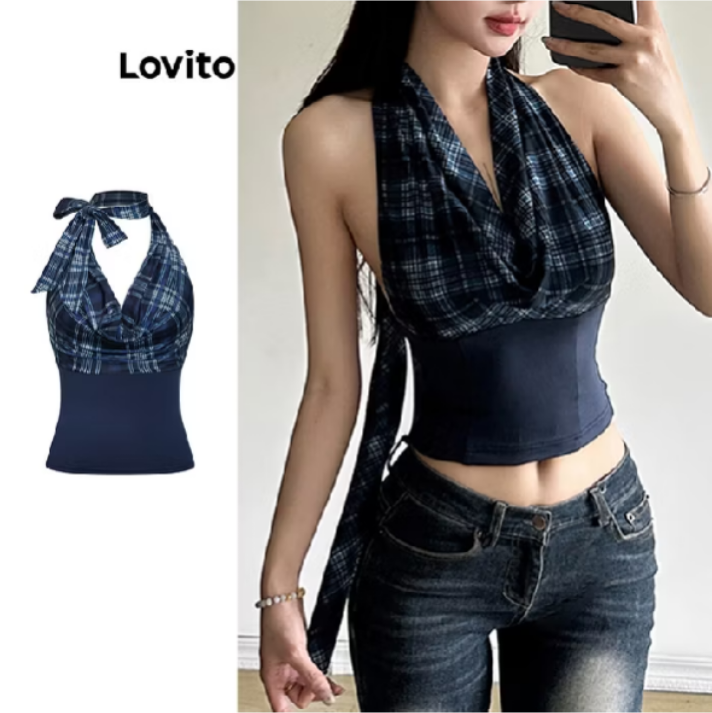 Woman in a plaid halter top and jeans, holding a phone