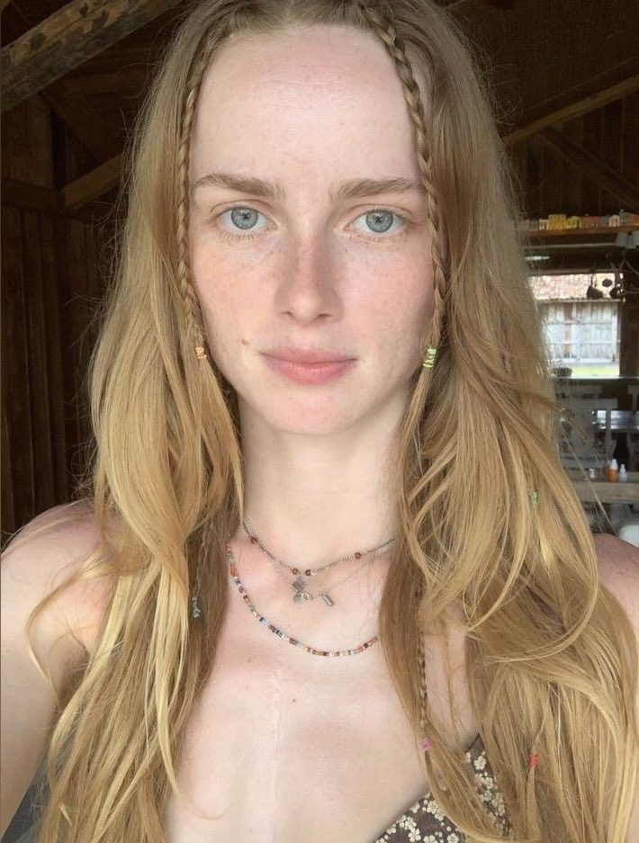 Woman with long blonde hair and blue eyes looking at the camera