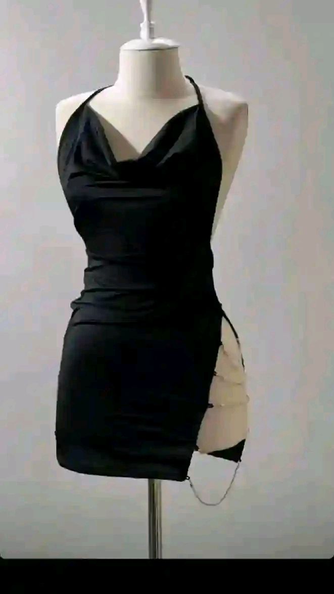 Black halter neck dress with a draped neckline and chain detail on a mannequin