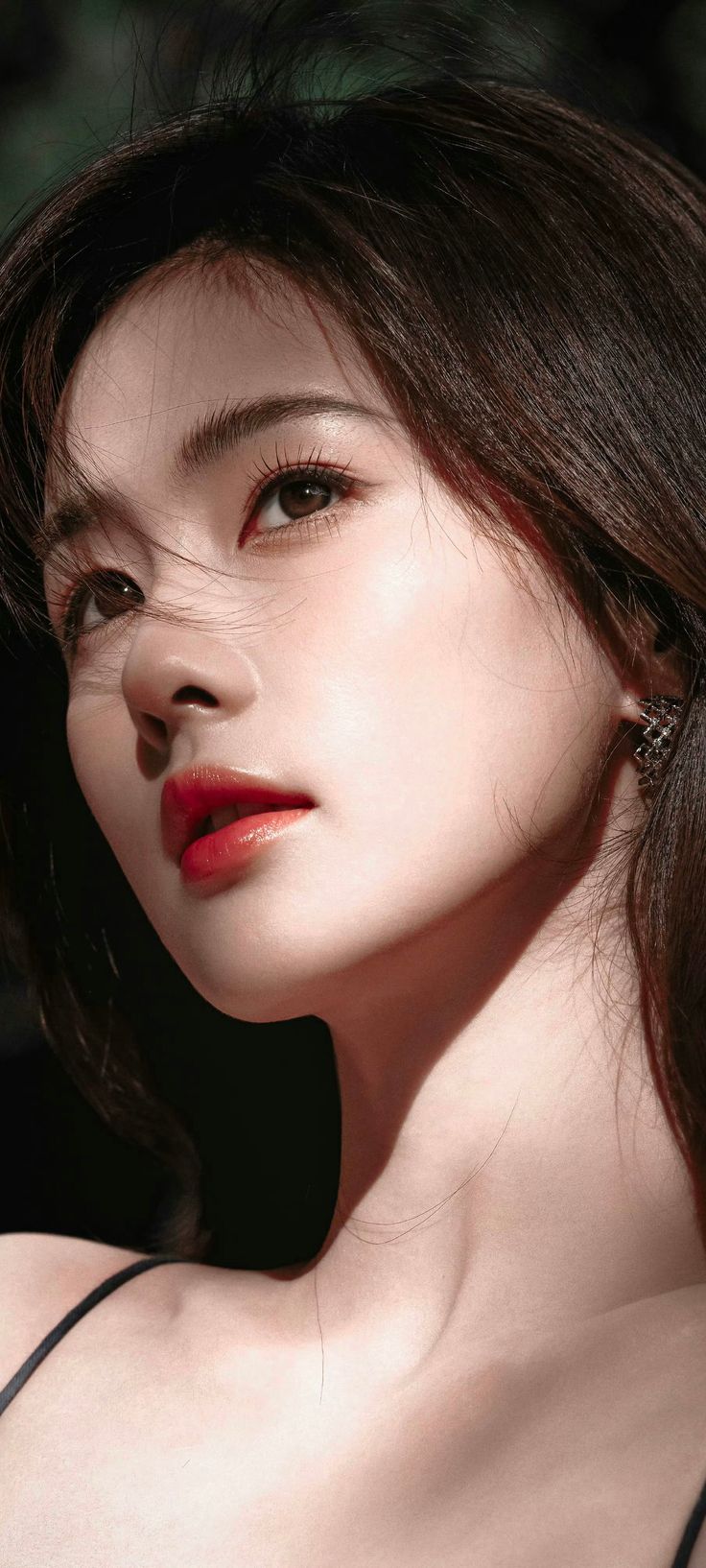 Close up portrait of a woman with long hair and red lipstick