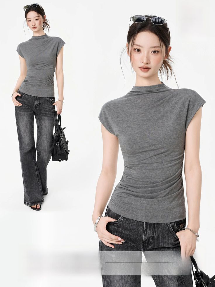 Woman in a gray top and wide-leg jeans with sunglasses on her head