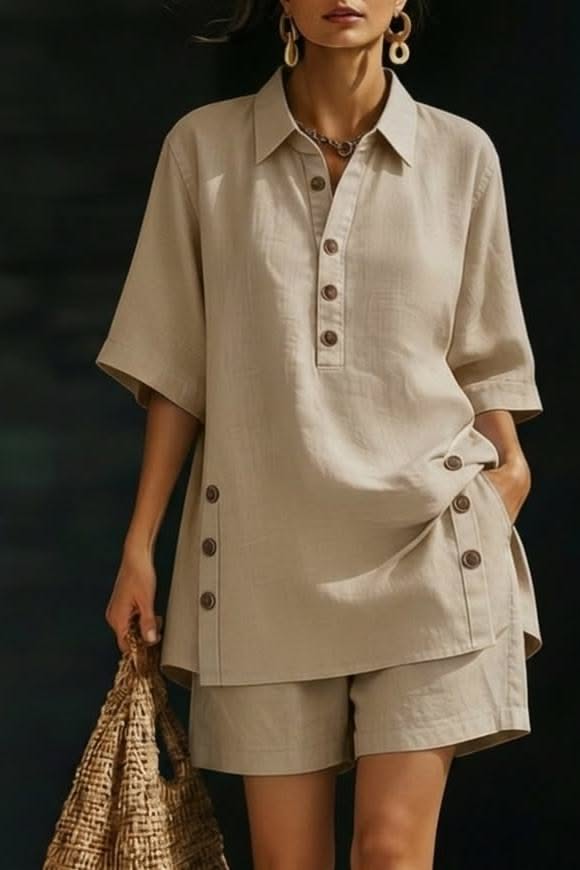 Woman in a beige linen shirt and shorts holding a straw bag