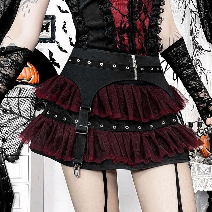 Person in gothic attire with a layered mini skirt and garter belt