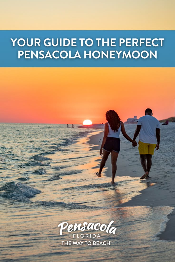 Couple walking hand in hand on a beach at sunset