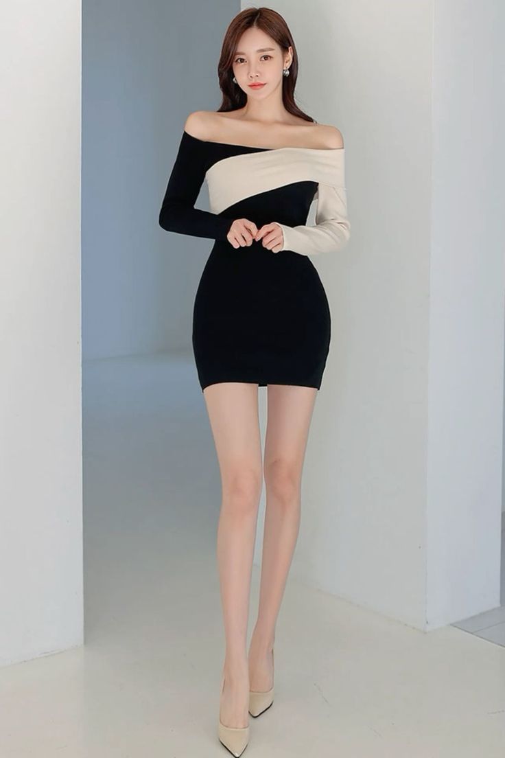 Woman in a black and white off-shoulder bodycon dress and high heels