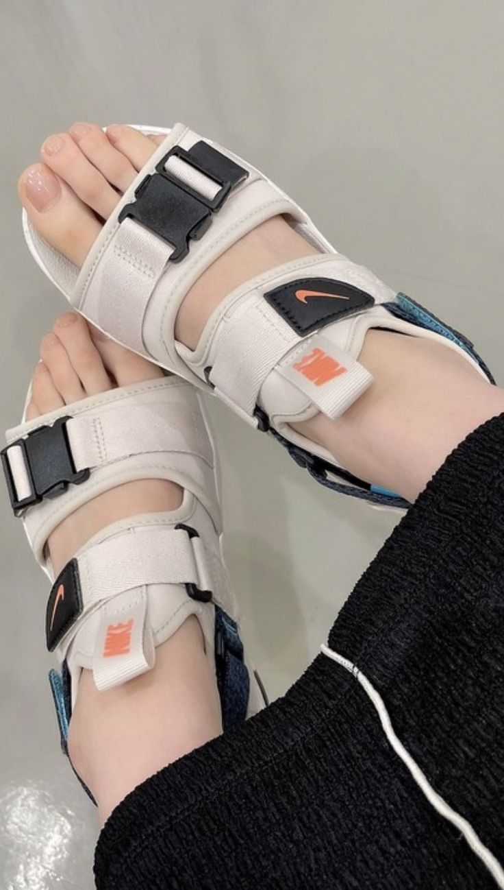 Person wearing sport sandals and black pants indoors