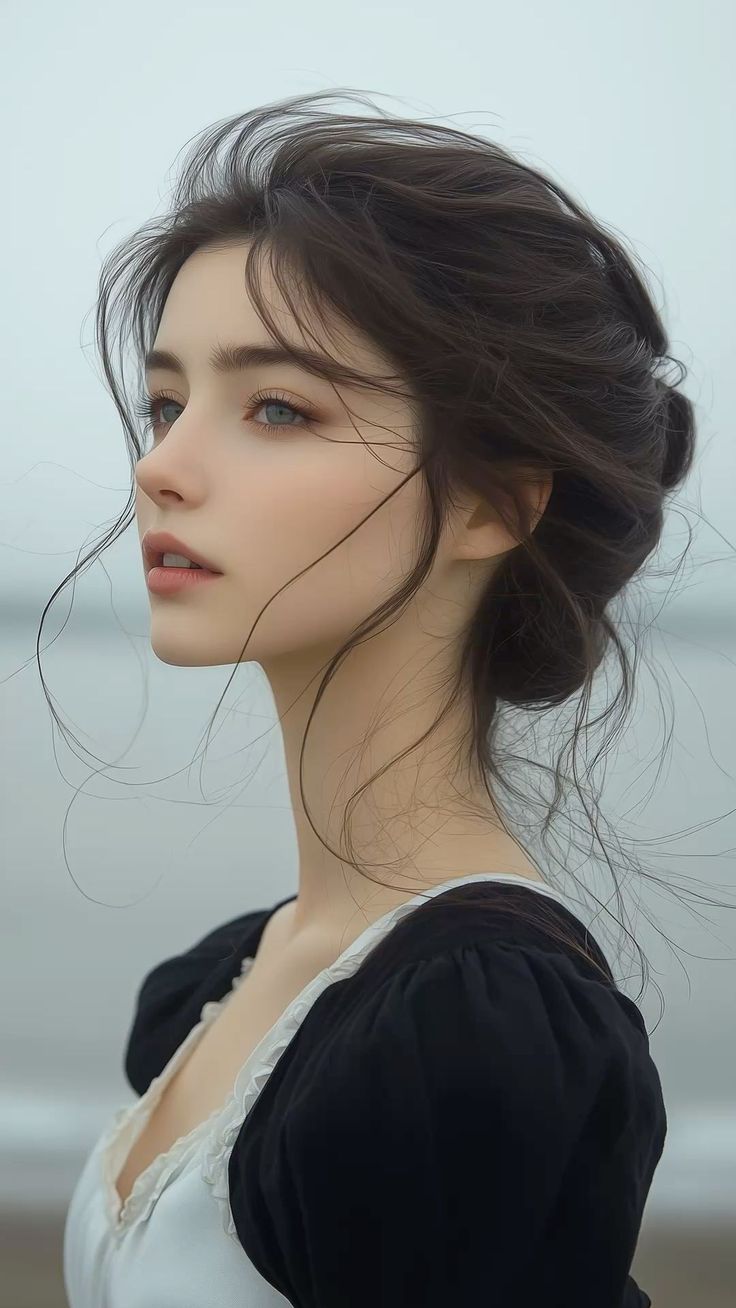 Woman with dark hair in an updo wearing a black dress with white trim outdoors