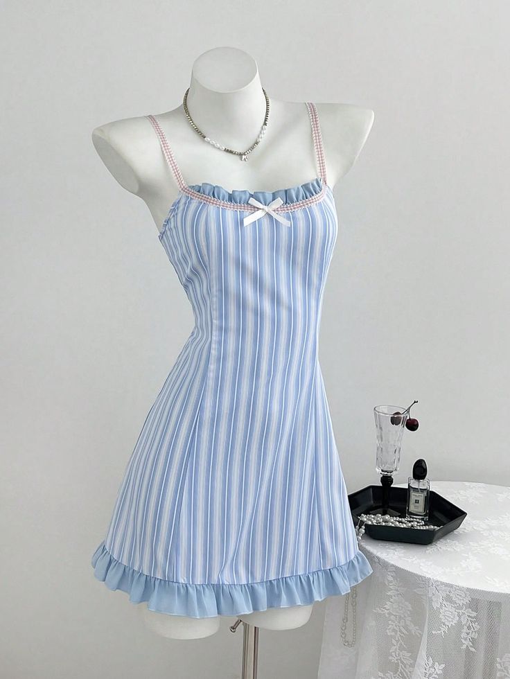 Blue and white striped dress with ruffle trim on a mannequin