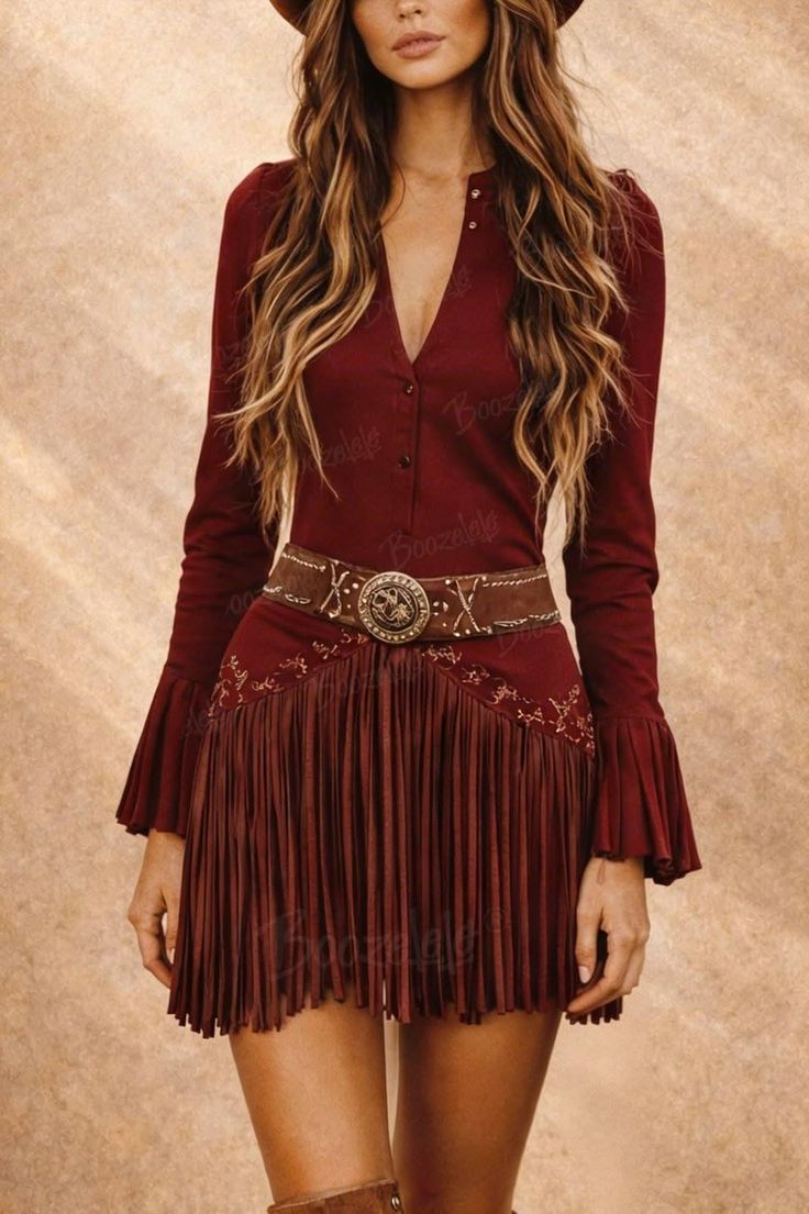 Woman in a red fringe dress and cowboy hat with exposed skin