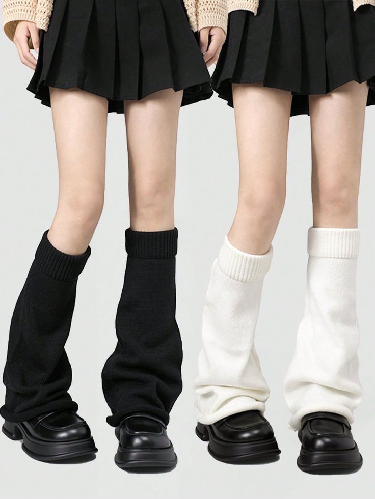 Two people wearing pleated skirts, leg warmers, and chunky black shoes