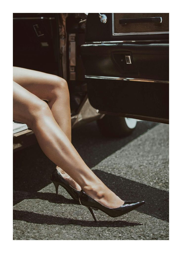 Woman's legs in high heels stepping out of a car