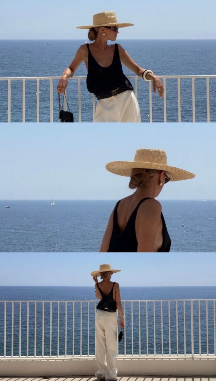 Woman in a straw hat and black tank top on a balcony overlooking the ocean