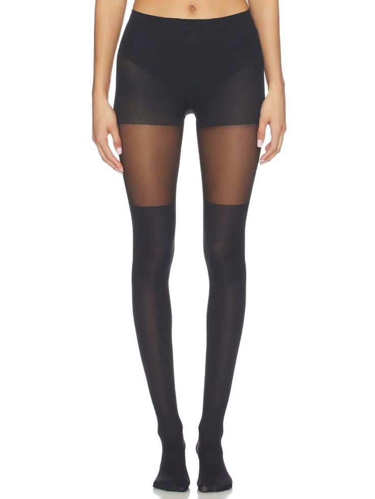 Person wearing black tights with sheer and opaque sections