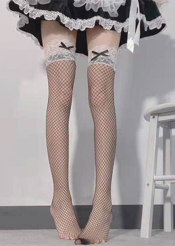 Person wearing fishnet stockings with lace trim and a maid dress