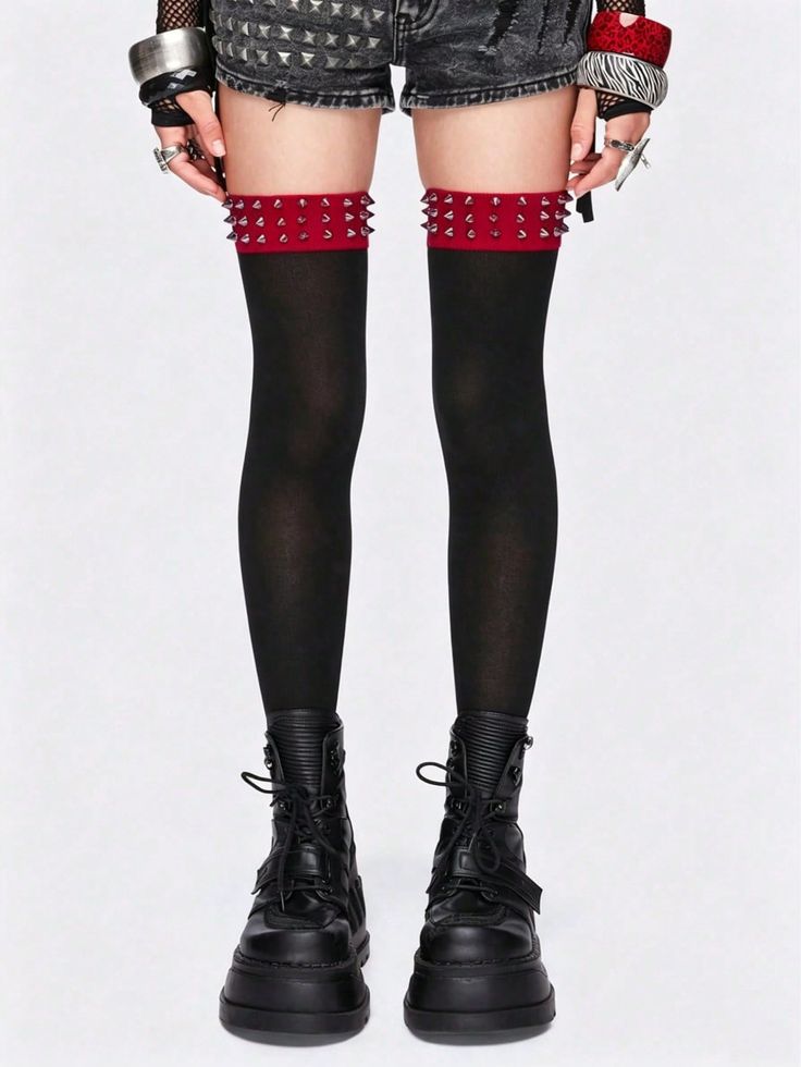 Person wearing black stockings with studded garters, denim shorts, and platform boots