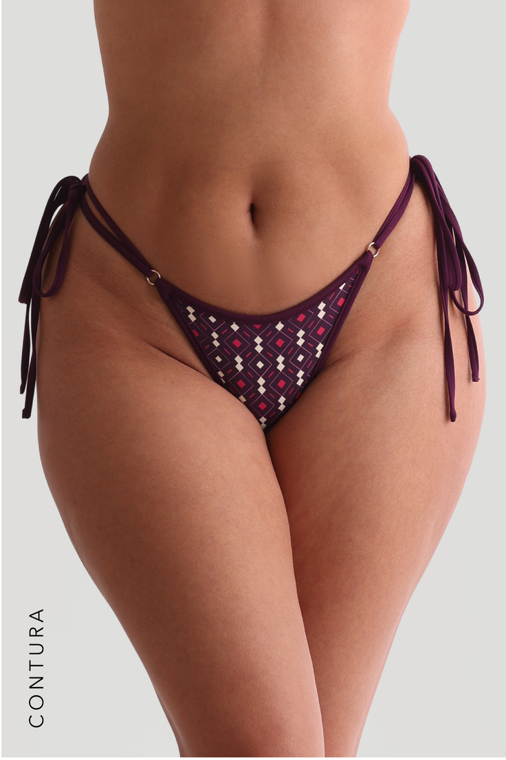 Close up of a woman wearing a patterned bikini bottom with tie sides
